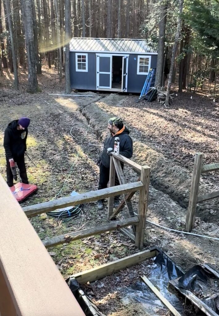 Convert a shed into a home office: electricians laying cable 