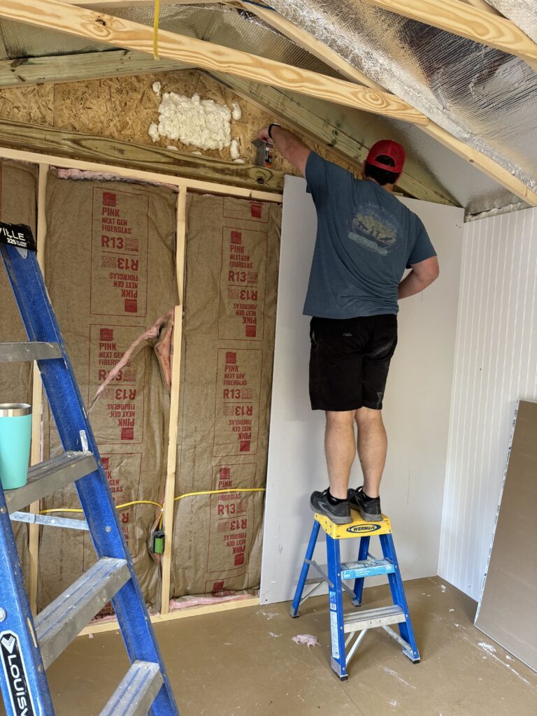 Insulate and finish shed walls: hanging drywall 